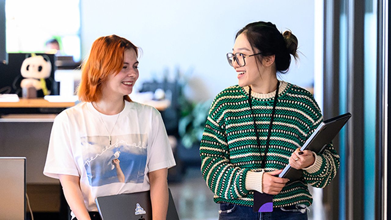 Two engineers walk to a meeting in the AppLovin office Two engineers walk to a meeting in the AppLovin office